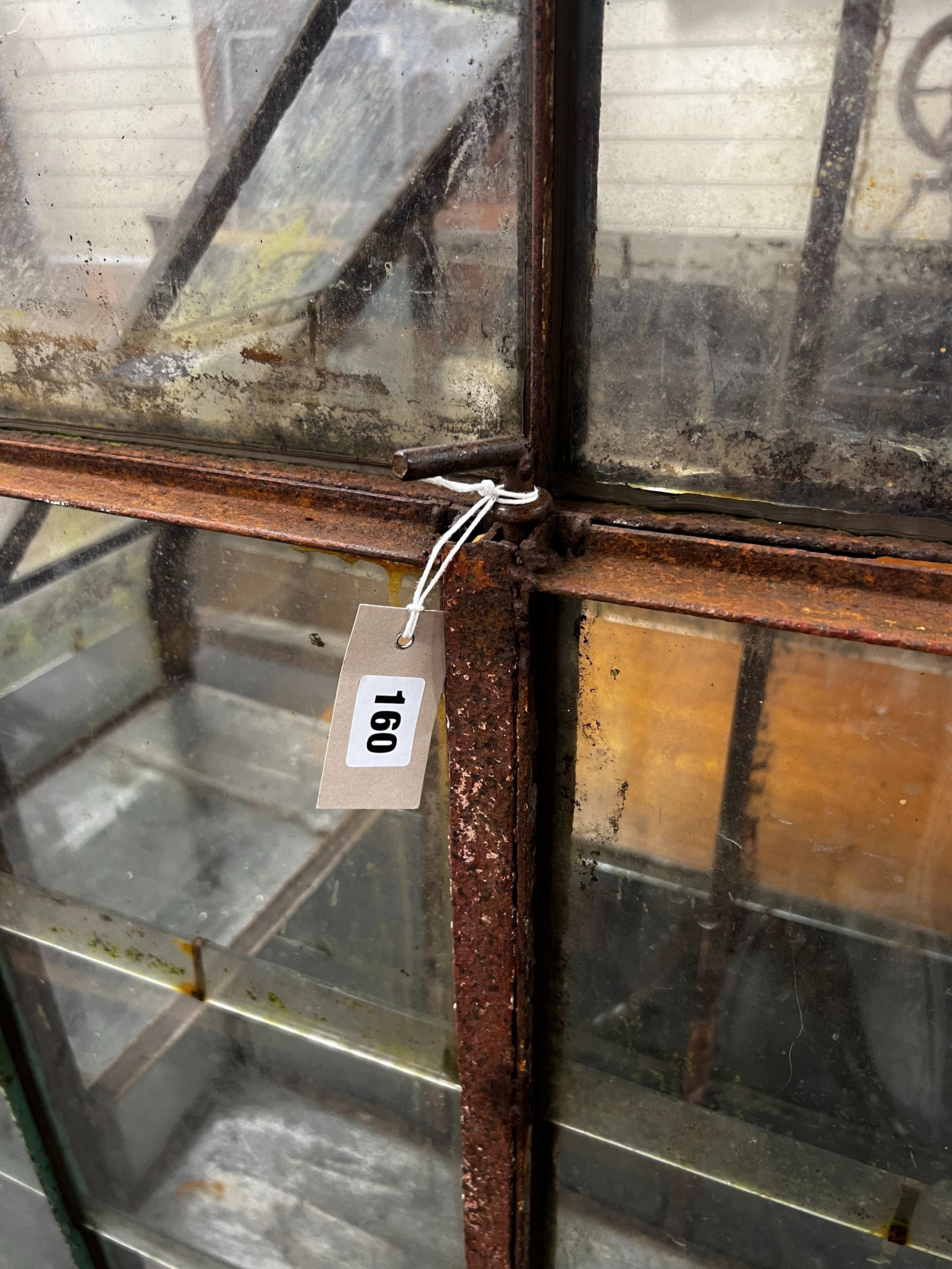 A vintage arched greenhouse on wheeled base, width 136cm, depth 51cm, height 174cm